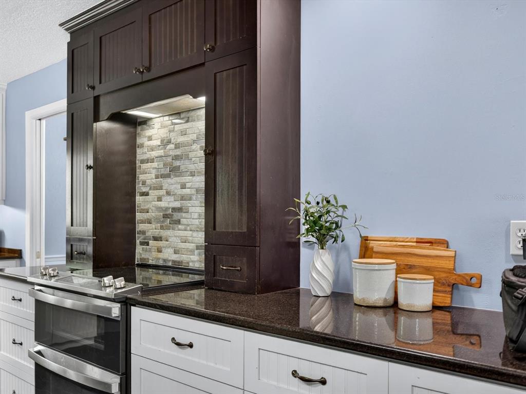 333 Cornwall Road Winter Park, FL 32792 - Photo 5 of 32 a kitchen with granite countertop a sink stainless steel appliances and cabinets