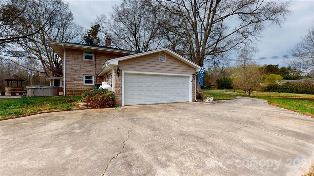 185 Rainey Road Salisbury, NC 28146 - Photo 21 of 47 a front view of a house with a yard and garage