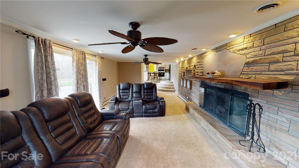 185 Rainey Road Salisbury, NC 28146 - Photo 34 of 47 a living room with furniture and a chandelier