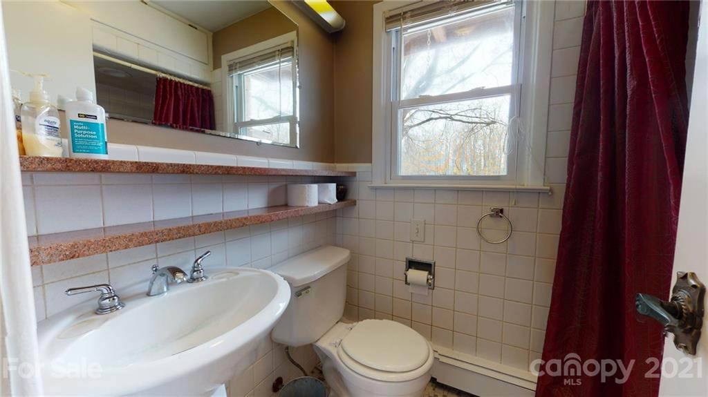 185 Rainey Road Salisbury, NC 28146 - Photo 36 of 47 a bathroom with a sink mirror toilet and window
