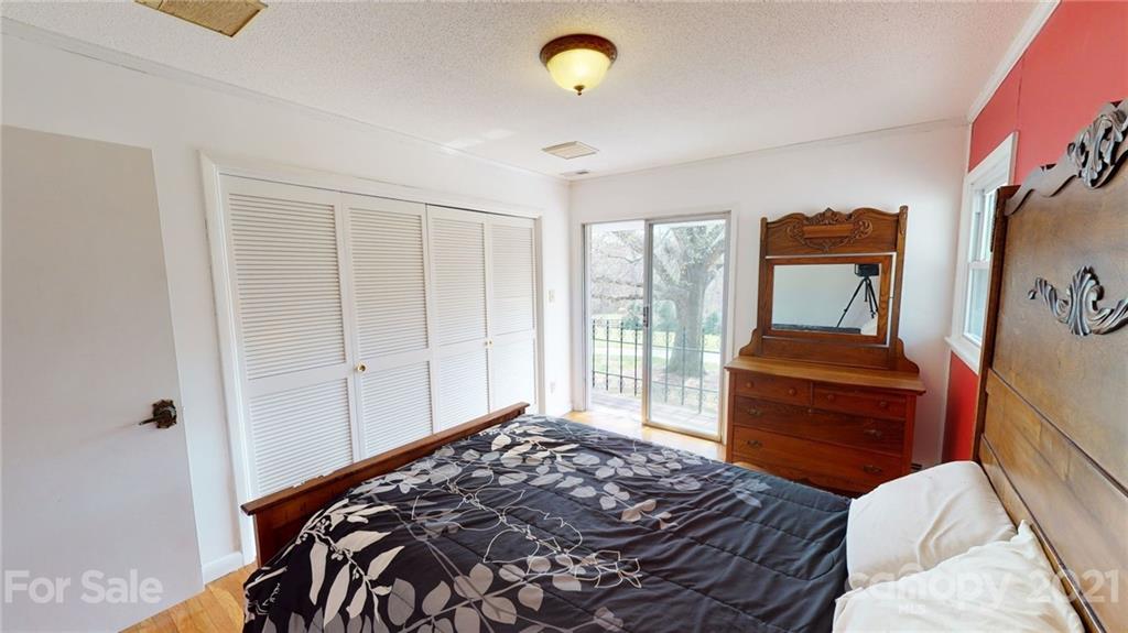 185 Rainey Road Salisbury, NC 28146 - Photo 39 of 47 a bedroom with a bed and wooden floor