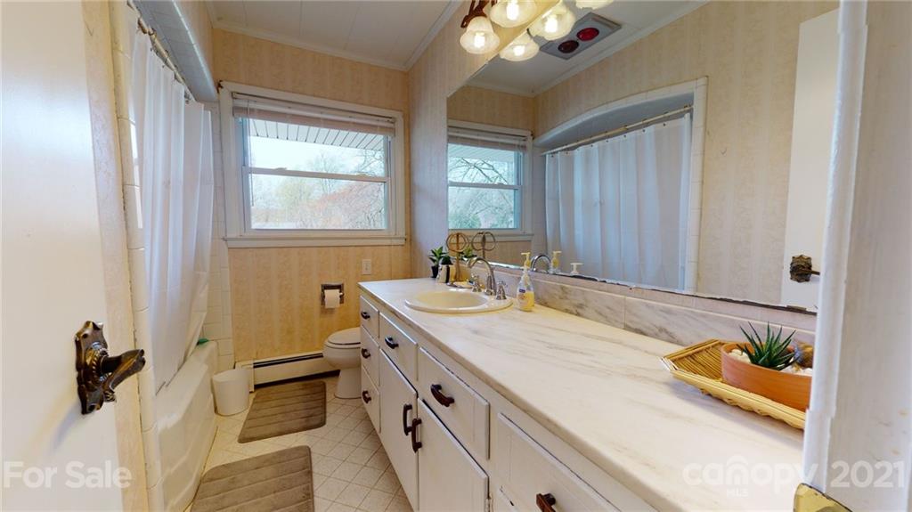 185 Rainey Road Salisbury, NC 28146 - Photo 41 of 47 a bathroom with a granite countertop sink and a large mirror