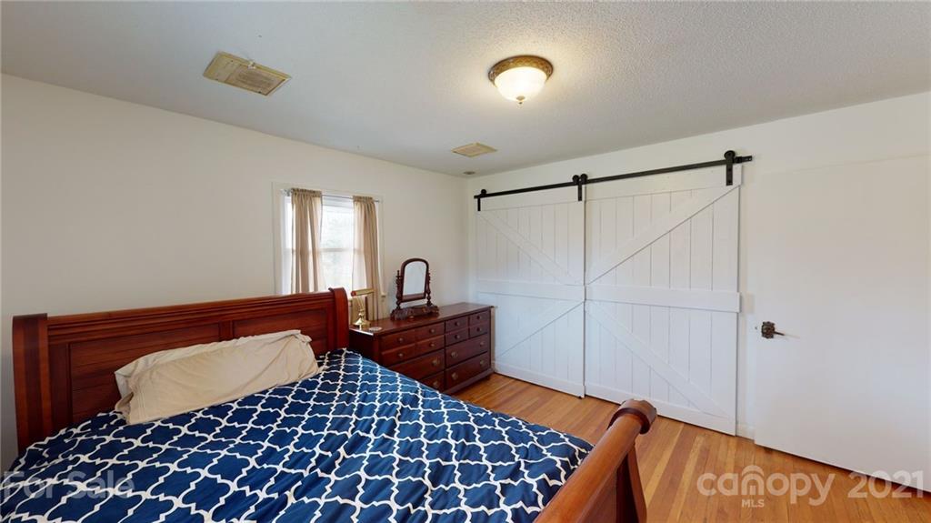 185 Rainey Road Salisbury, NC 28146 - Photo 42 of 47 a bedroom with a bed and a lamp on dresser