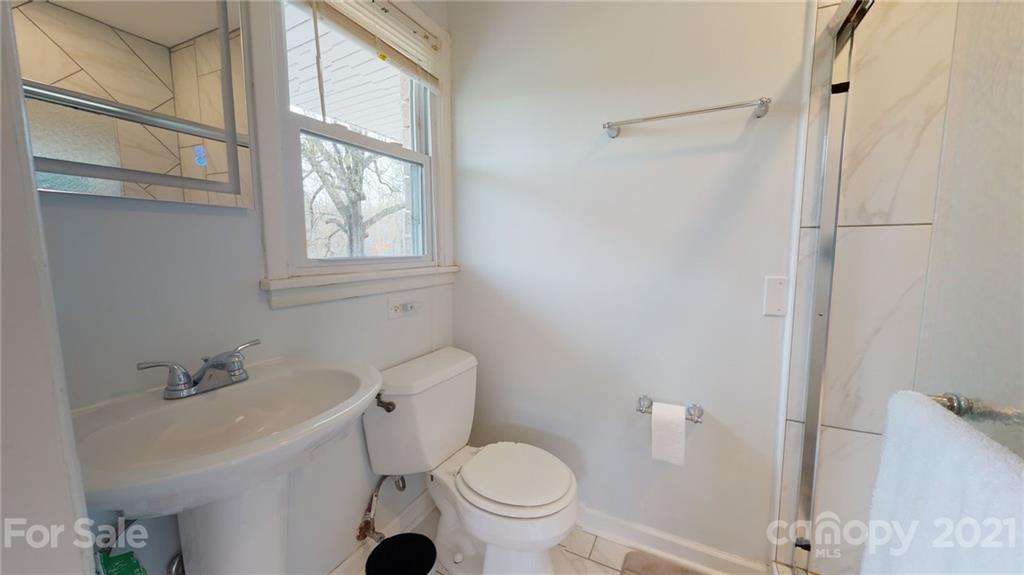 185 Rainey Road Salisbury, NC 28146 - Photo 44 of 47 a white toilet sitting next to a bathroom sink