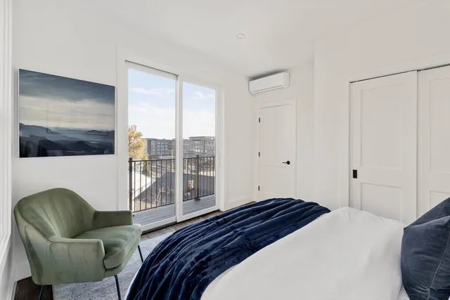 a bedroom with a bed couch and window