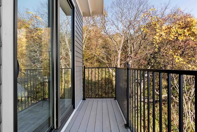 a view of balcony with wooden floor