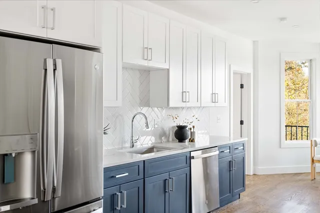 a kitchen with stainless steel appliances a refrigerator and sink