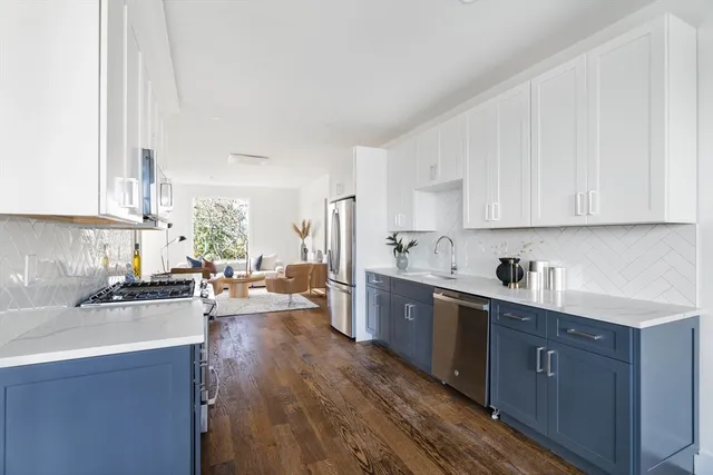 a kitchen with sink a stove and cabinets