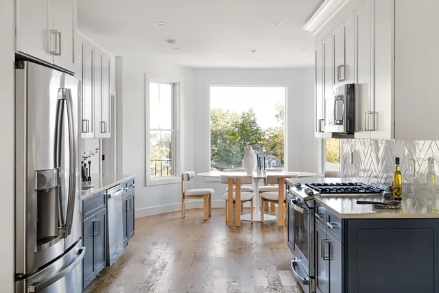 a kitchen with stainless steel appliances a sink stove and refrigerator