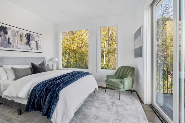 a bedroom with a bed and a large window