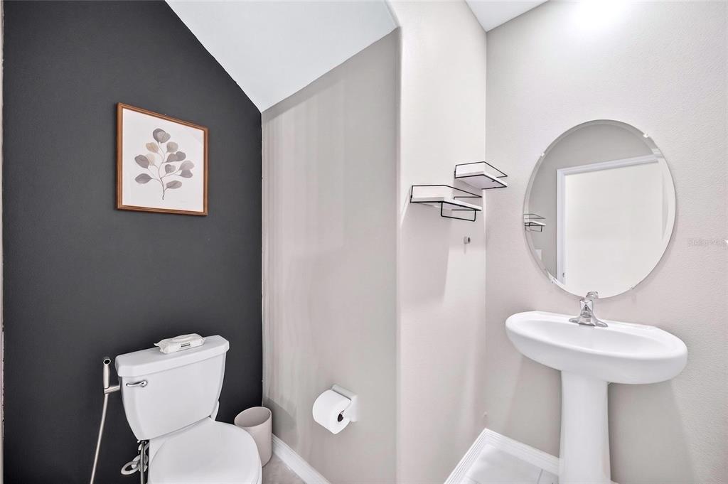 31724 Sun Kettle Loop Wesley Chapel, FL 33545 - Photo 16 of 49 a bathroom with a toilet sink and mirror