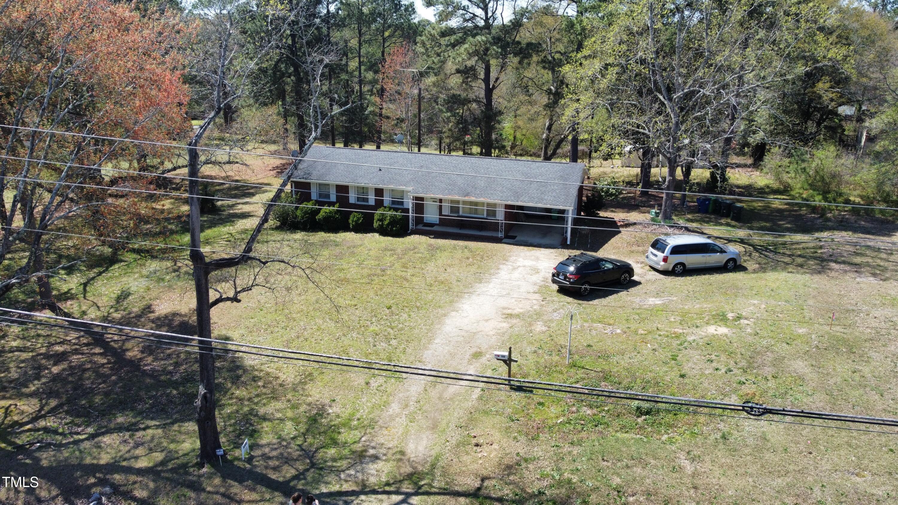640 Sunnybrook Road Raleigh, NC 27610 - Photo 7 of 12 a view of a swimming pool with potted plants and large trees
