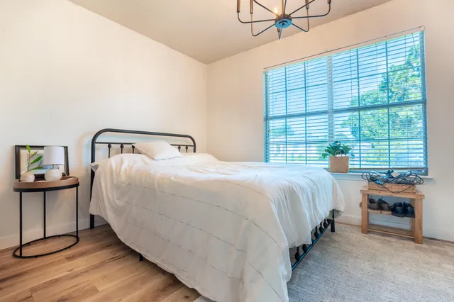 a bedroom with a bed next to a window with outer view