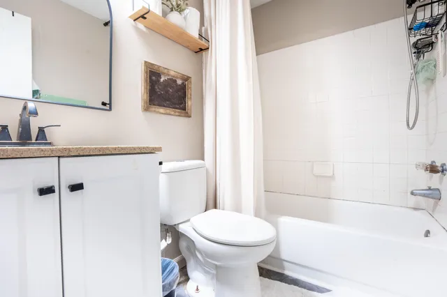 a bathroom with a toilet sink and shower