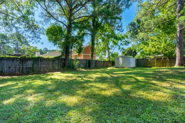 a view of a yard with a house in the background