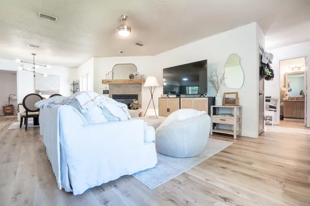a living room with furniture a fireplace and a flat screen tv