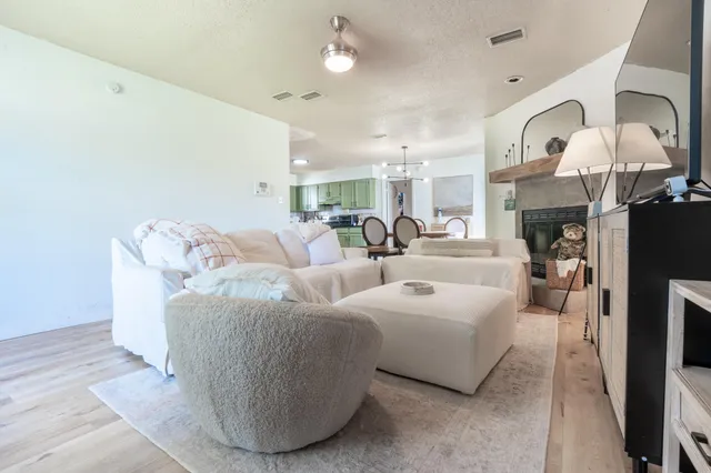 a living room with furniture chandelier and fireplace
