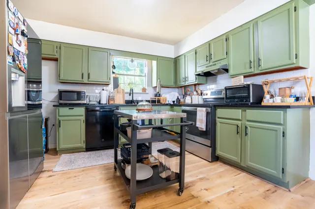 a kitchen with a sink cabinets and dining table chair