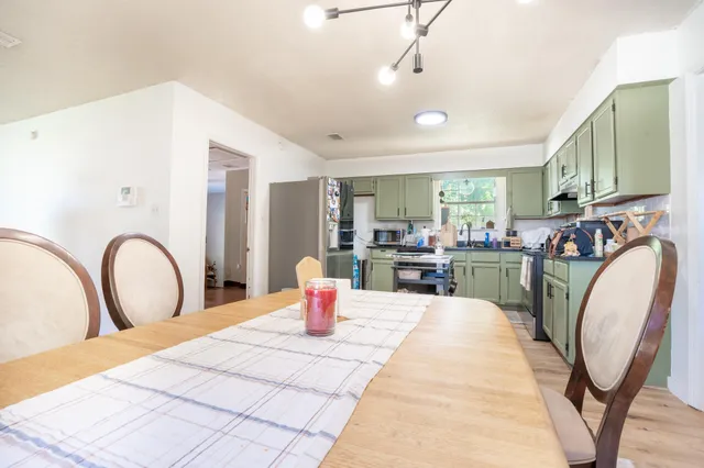 a living room with furniture a rug and white walls