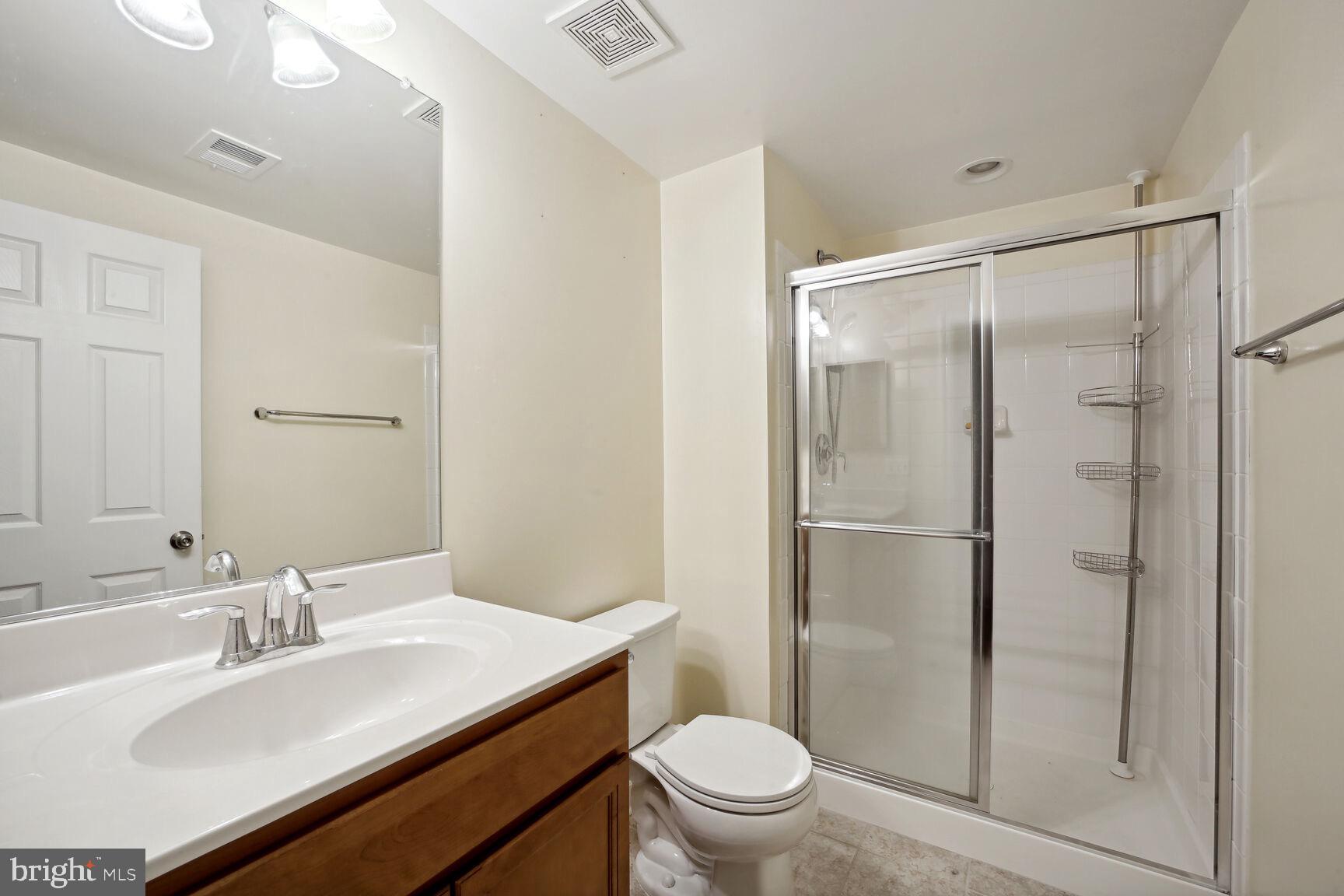 6201 Hunt Weber Drive Clinton, MD 20735 - Photo 12 of 30 a bathroom with a granite countertop sink toilet and shower