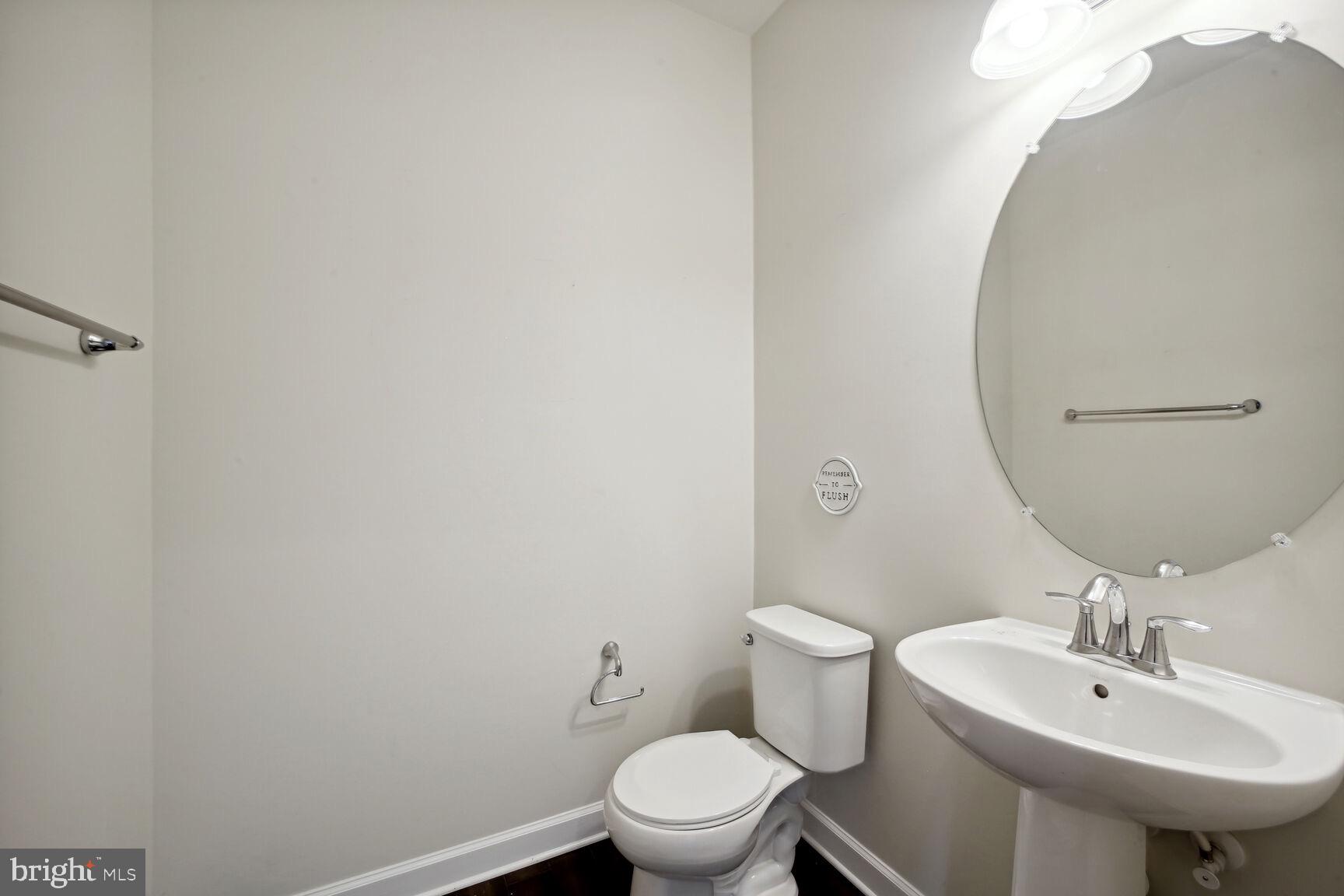 6201 Hunt Weber Drive Clinton, MD 20735 - Photo 14 of 30 a bathroom with a sink a toilet and a mirror