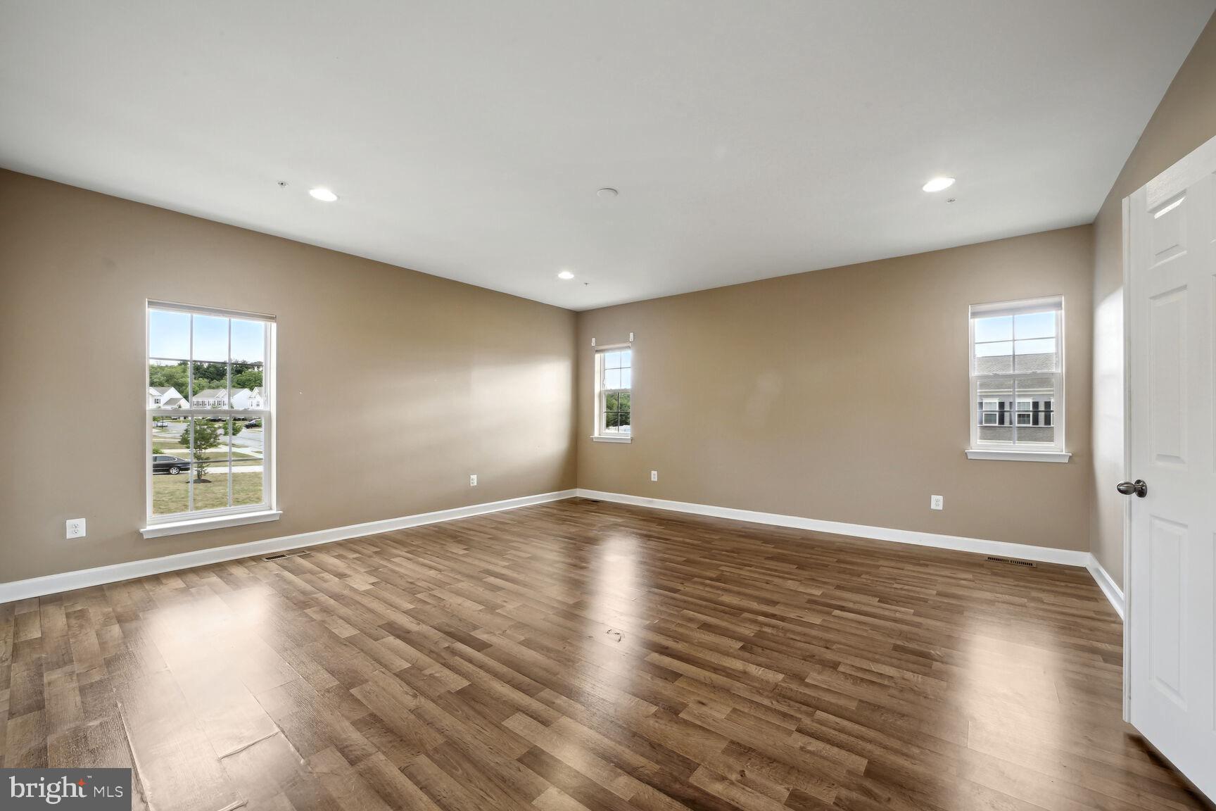 6201 Hunt Weber Drive Clinton, MD 20735 - Photo 16 of 30 an empty room with wooden floor and windows