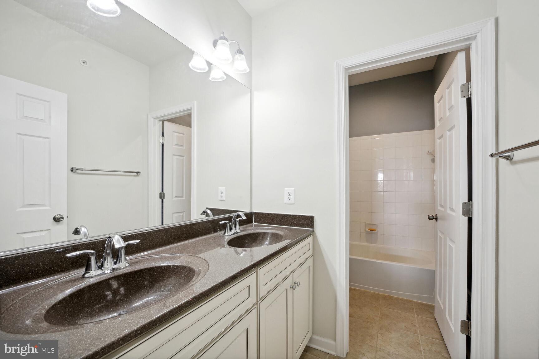6201 Hunt Weber Drive Clinton, MD 20735 - Photo 20 of 30 a bathroom with a sink double vanity and a shower