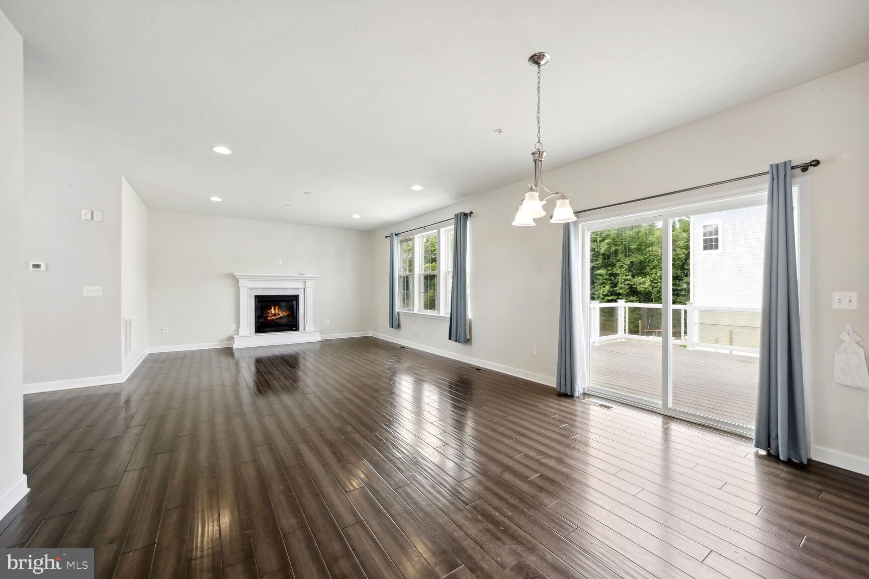 6201 Hunt Weber Drive Clinton, MD 20735 - Photo 4 of 30 a view of empty room with wooden floor and fan