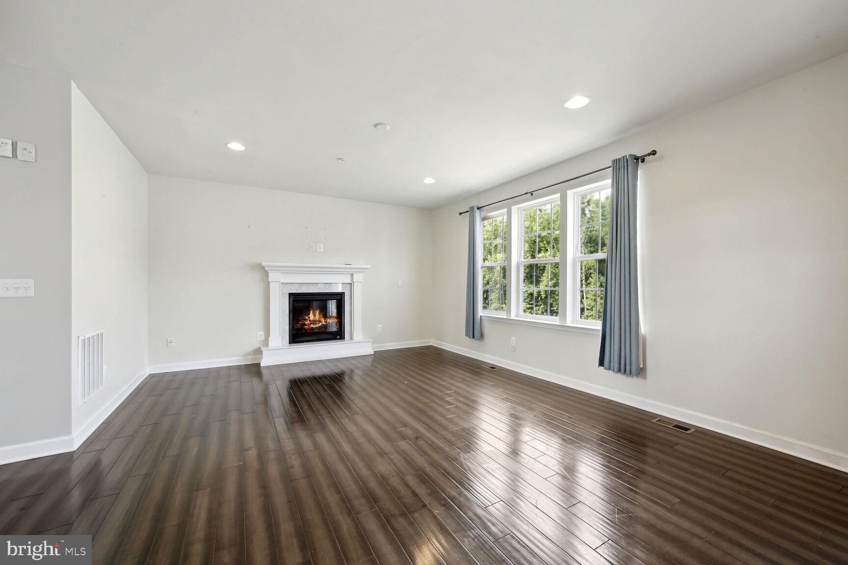 6201 Hunt Weber Drive Clinton, MD 20735 - Photo 5 of 30 a view of an empty room with wooden floor and a window