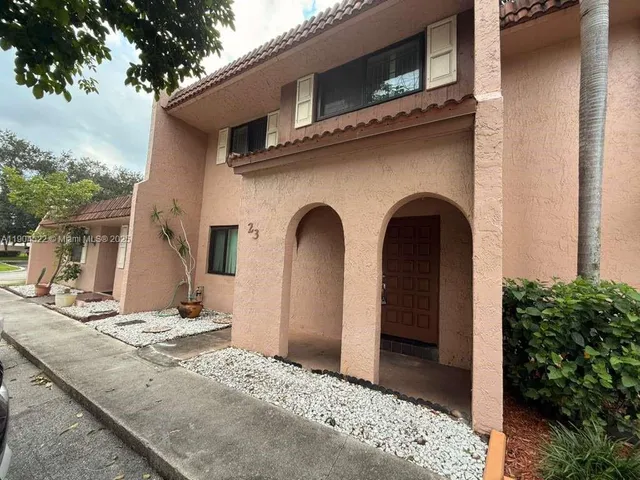 a front view of a house with parking