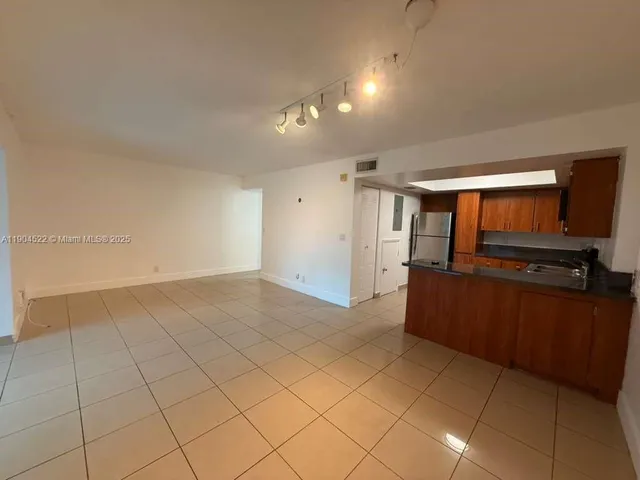 a view of a kitchen with cabinets
