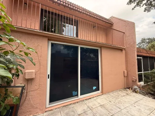 a view of a house with a wooden fence