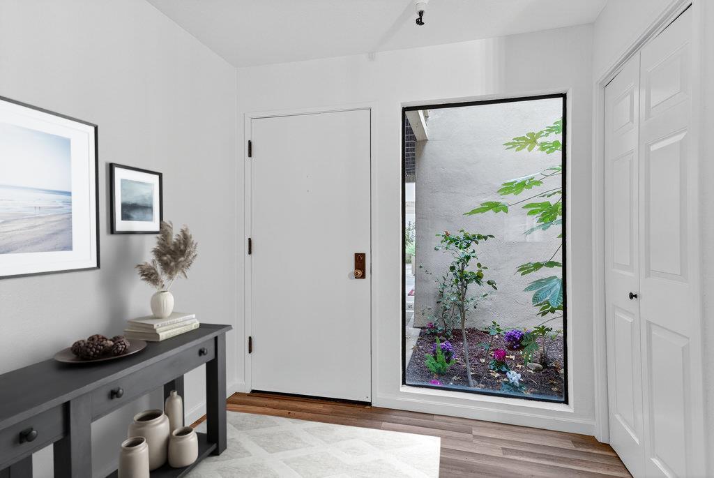 a room with painting on the wall and a potted plant