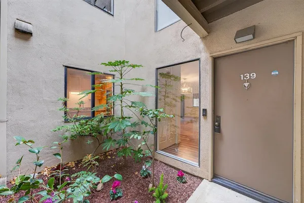a view of a porch with furniture and garden