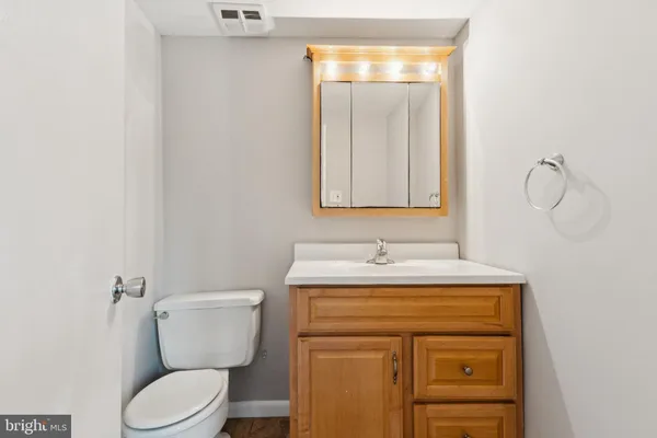 a bathroom with a toilet sink and mirror