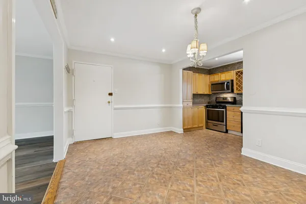 a view of a kitchen with a sink stainless steel appliances and cabinets