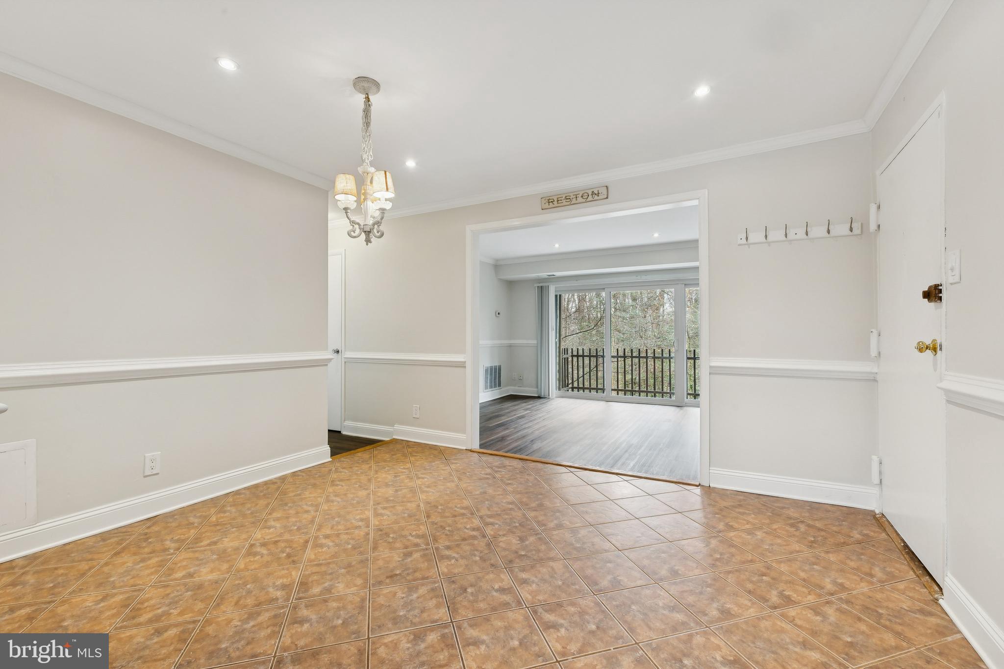 11611 Vantage Hill Road, Unit 11B Reston, VA 20190 - Photo 8 of 17 wooden floor in an empty room with a window