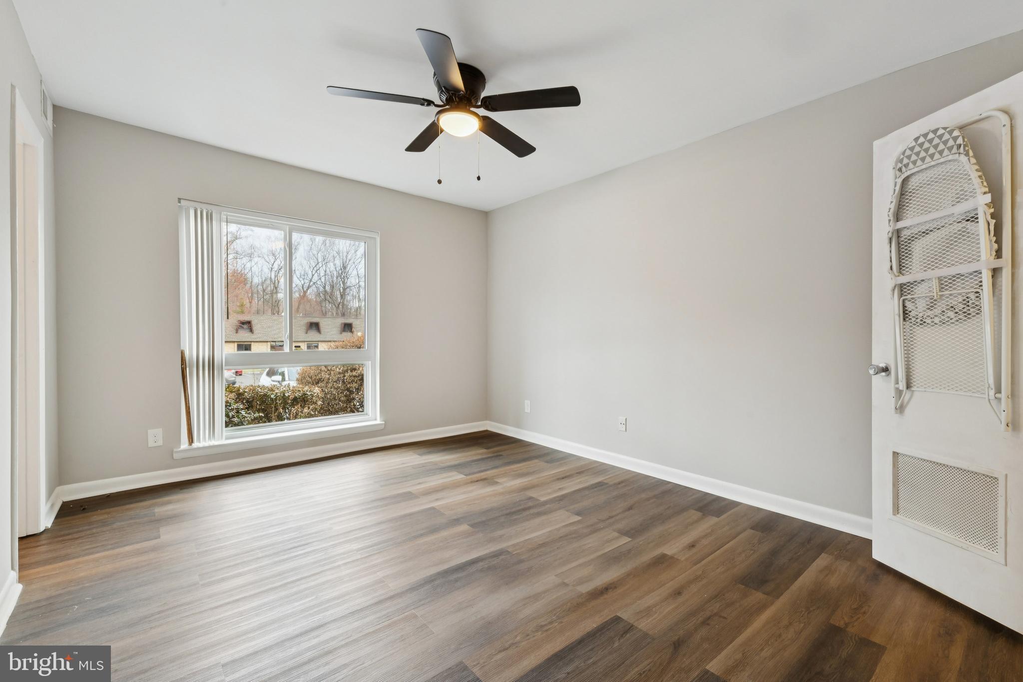 11611 Vantage Hill Road, Unit 11B Reston, VA 20190 - Photo 10 of 17 a view of an empty room with wooden floor and a window