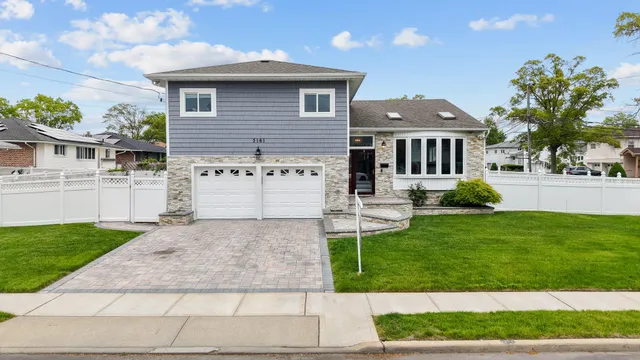 a view of a house with a yard and a garden