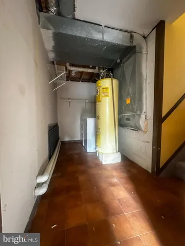 a view of a room with wooden floor and a hallway