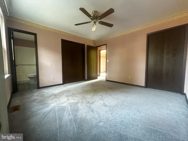 a view of a livingroom with a ceiling fan and window