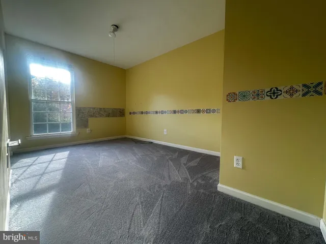 an empty room with a empty space and windows