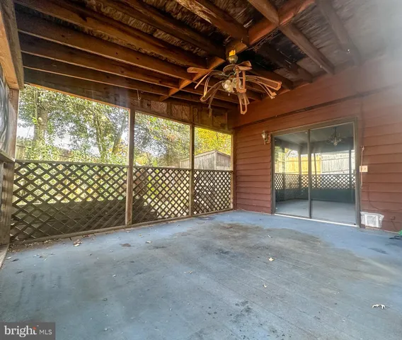 a view of empty room with wooden walls