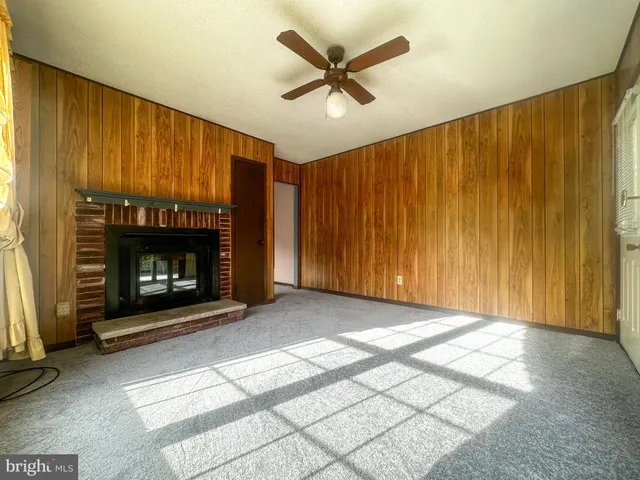 a living room with a fireplace window and a fireplace