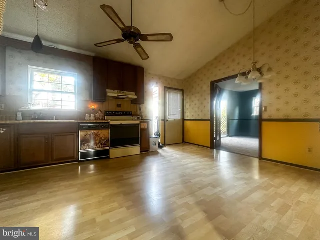 a view of a kitchen with a stove cabinets and a kitchen