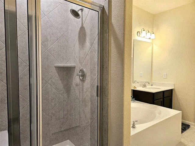 a bathroom with a tub sink and mirror