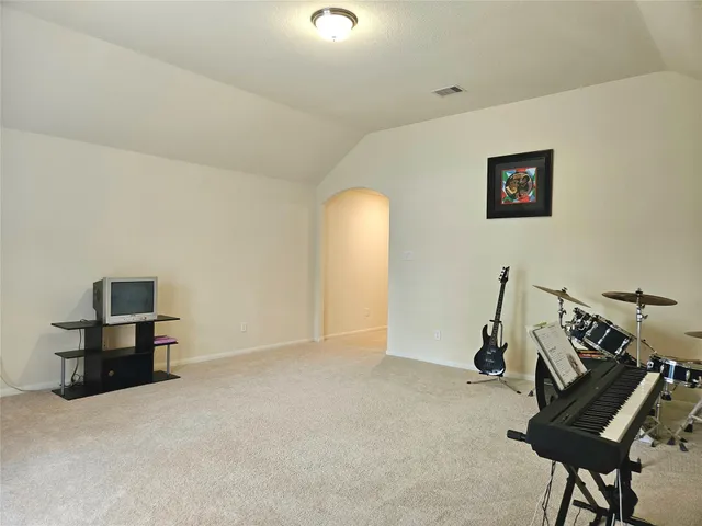 a view of a room with furniture and a ceiling fan