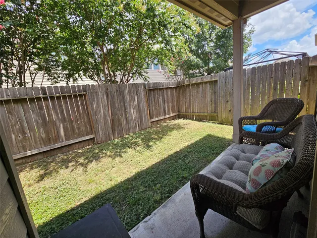 a backyard of a house with table and chairs
