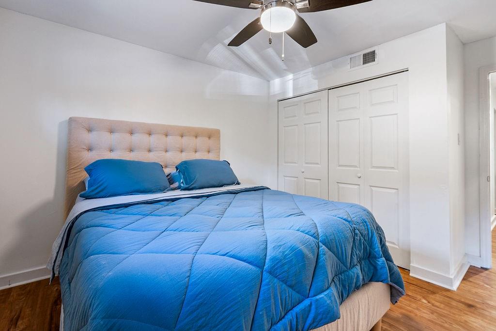 1133 Clairemont Avenue, Unit D Decatur, GA 30030 - Photo 13 of 20 a bedroom with a bed and ceiling fan