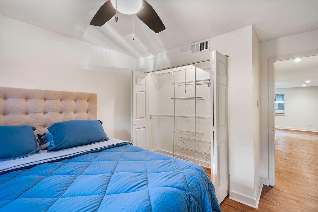 1133 Clairemont Avenue, Unit D Decatur, GA 30030 - Photo 14 of 20 a bedroom with a large bed and wooden floor